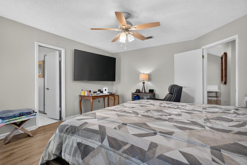Bedroom with TV and desk at 8680 Bandera Cir S, Jacksonville, FL 32244