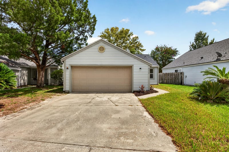 Front exterior with two-car garage and driveway at 8047 Mactavish Way E, Jacksonville, FL 32244