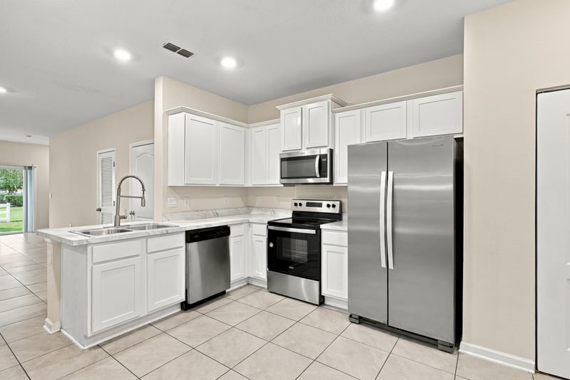 Kitchen view toward window with stainless appliances at 9555 Star Dr, Jacksonville, FL 32256