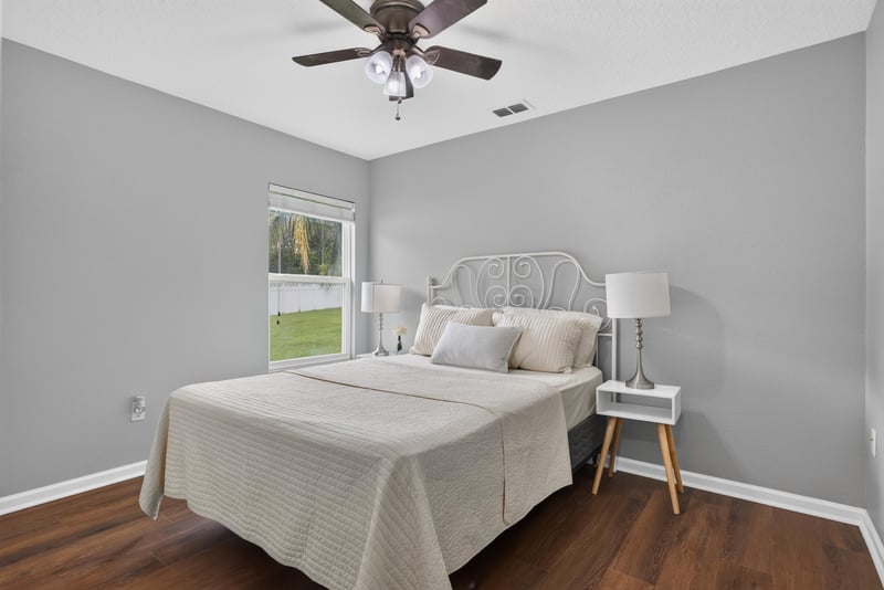 Bedroom with staged bed at 706 Grampian Highlands Dr, St. Johns, FL 32259