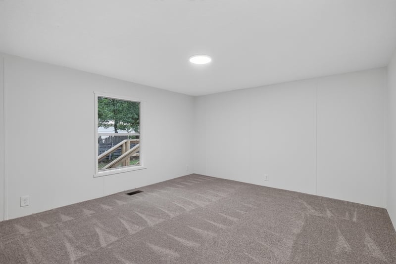 Bedroom with carpet and window at 55520 Jewel-Thomas Rd, Callahan, FL 32011