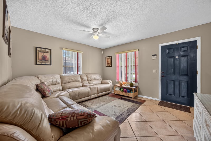 Living room with sectional and black front door at 5375 Dodge Rd, Jacksonville, FL 32209