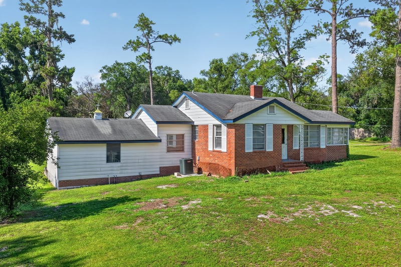 Front exterior of brick ranch home with long driveway at 5745 110th St, Jacksonville, FL 32244
