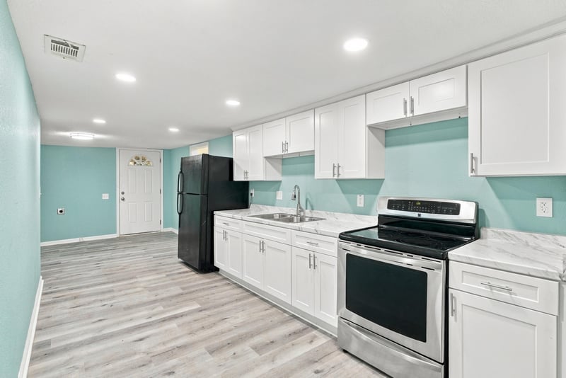 Kitchen with white cabinetry, photographed by Megapixeler on W 24th St, Jacksonville