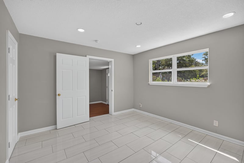Empty room with tile floor and window at 7015 Miss Muffet Ln N, Jacksonville, FL 32210