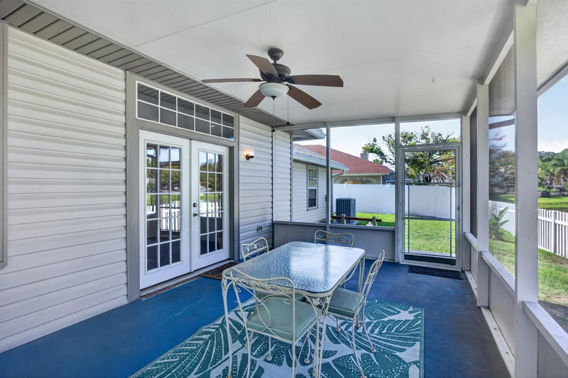 Screened porch with table and chairs at 11828 Heather Grove Ln, Jacksonville, FL