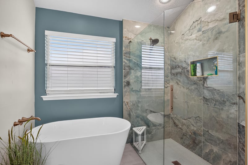 Primary bathroom walk-in shower with marble tile at 3112 Silverado Cir, Green Cove Springs, FL 32043