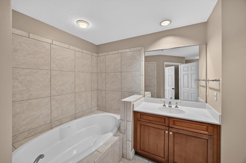 Bathroom with tub, tile surround and vanity at 1478 Riverplace Blvd 1904, Jacksonville, FL 32207