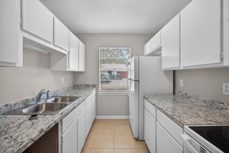 Kitchen with cabinets and window at 1040 Willow Cove Ct E, Jacksonville, FL 32233