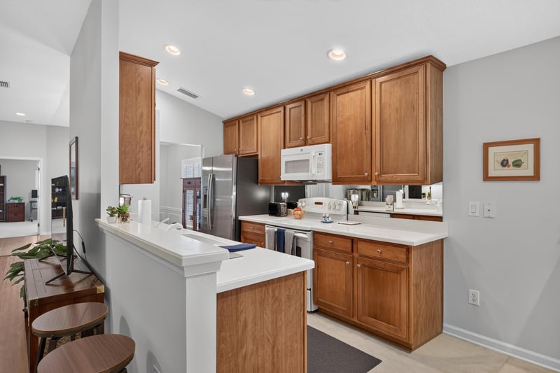 Kitchen with wood cabinets and white countertops at 11225 Water Spring Cir, Jacksonville, FL 32256