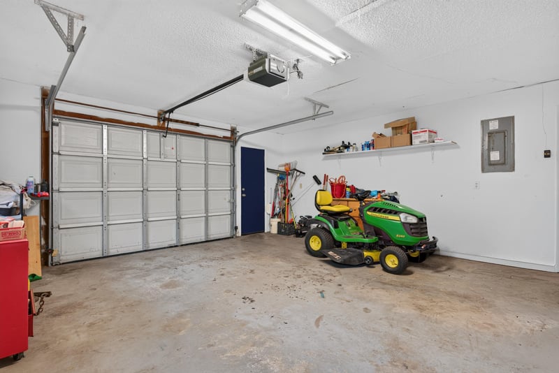 Two-car garage interior with workbench and shelving at 3249 Maryland Ave, Green Cove Springs, FL
