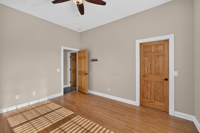 Bedroom with hardwood floors and sunlit window at 1735 Hagans Ridge Ct