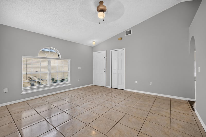 Living and dining area with vaulted ceiling and window at 7329 Lawn Tennis Ln, Jacksonville, FL
