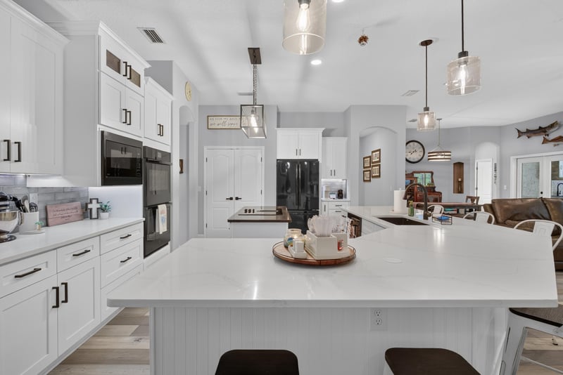 Kitchen island with white cabinetry at 2304 Spring Hill Ct, Orange Park, FL