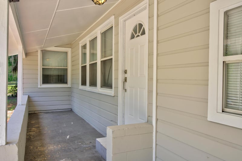 Covered front porch and entry door at 855 Cornwallis Dr, Jacksonville, FL