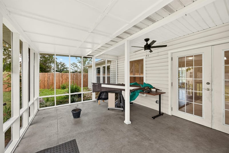 Screened porch with seating area at 9691 Nelson Forks Dr, Jacksonville, FL 32222
