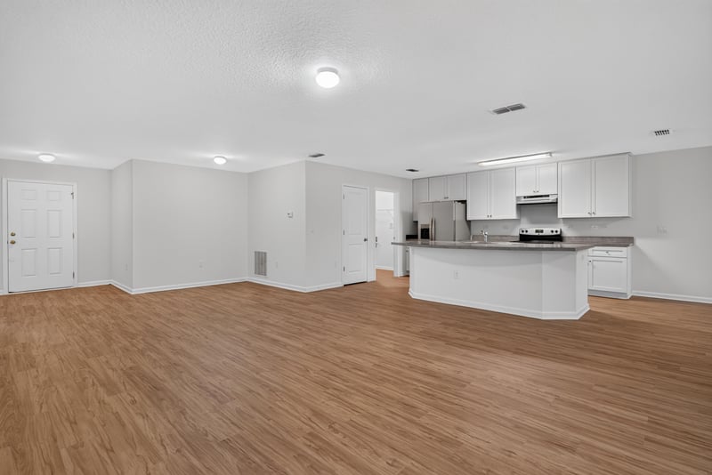 Open kitchen and living area with wood flooring at 95221 Siena Ct, Fernandina Beach, FL 32034