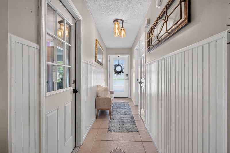 Hallway view toward front door and sidelight windows at 3067 Wavering Ln, Middleburg, FL 32068