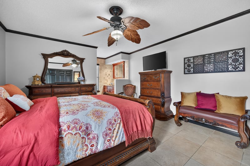 Bedroom with dresser and mirror at 6931 Cane Grass Ln E, Jacksonville, FL 32244