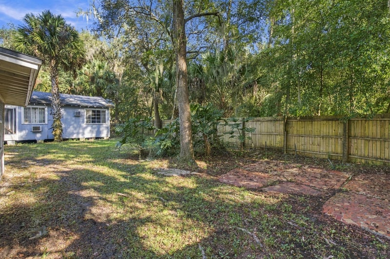 Open backyard bordered by a wood fence at 1807 Idlewild Ave, Green Cove Springs, FL