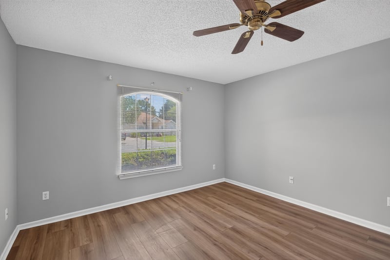 Bedroom with wood floor and window at 9256 Dale View Ln W, Jacksonville, FL 32225