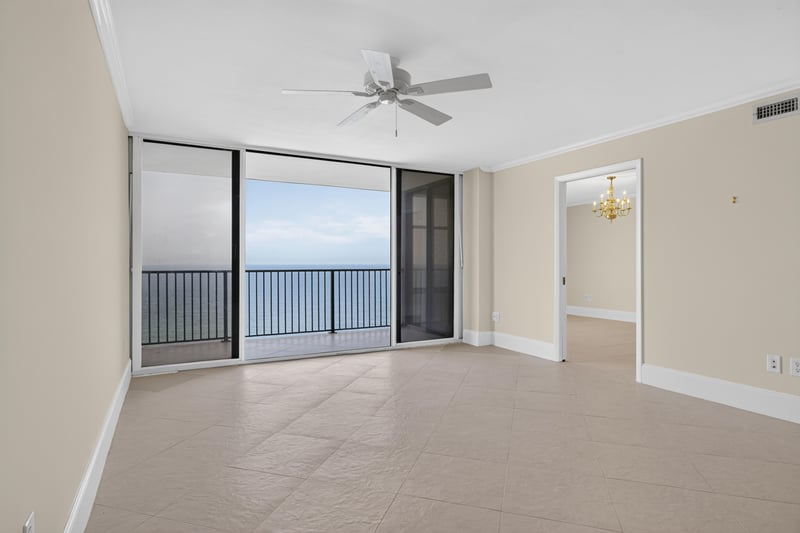 Living room with sliding glass doors to balcony and ocean view at 1301 1st St S