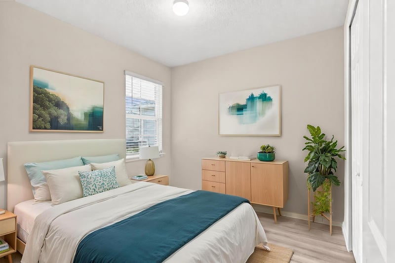 Staged bedroom with dresser and artwork at 7088 Mahogany Run Dr, Jacksonville, FL 32244