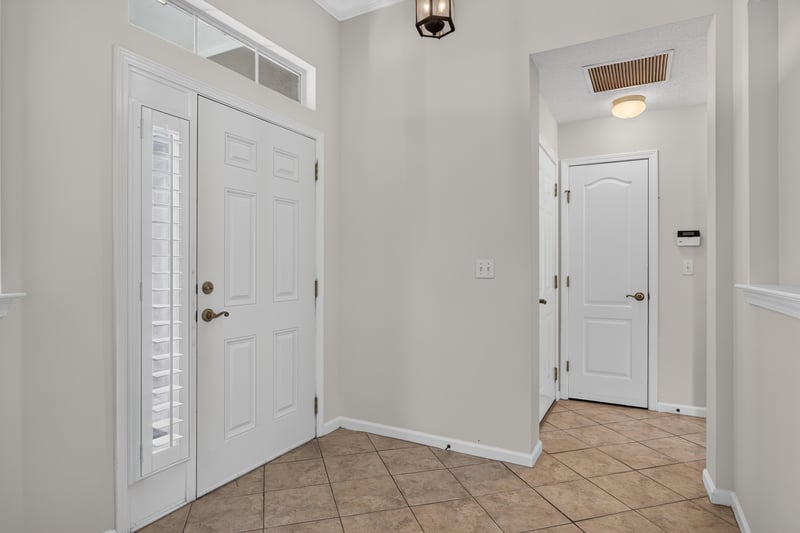 Foyer with tile floor and French doors at 2131 E Stone Creek Dr, Fleming Island, FL