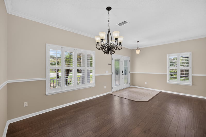 Living room with wood floors and plantation shutters at 1493 Greyfield Dr, St. Augustine, FL 32092