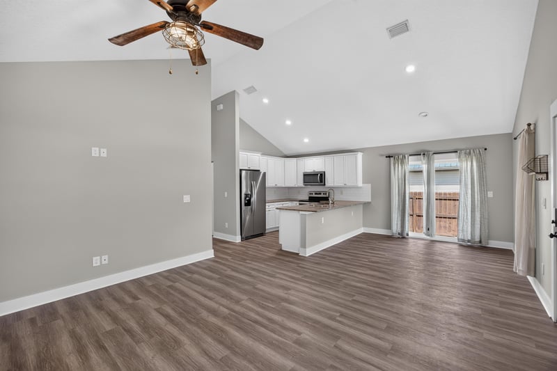 Living room with kitchen island and back door at 2855 N 8th St, St. Augustine, FL 32084