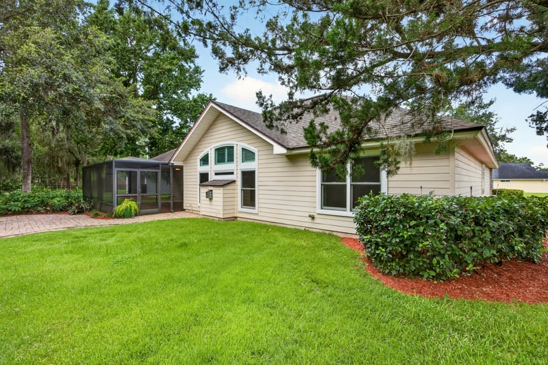 Backyard lawn and screened porch exterior at 1955 GUARDED Way, Fleming Island, FL 32003