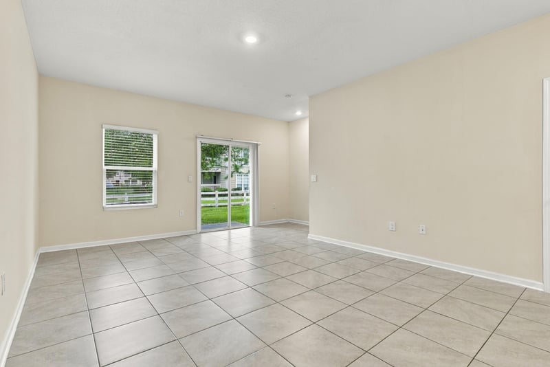 Empty living area with windows and tile flooring at 9555 Star Dr, Jacksonville, FL 32256