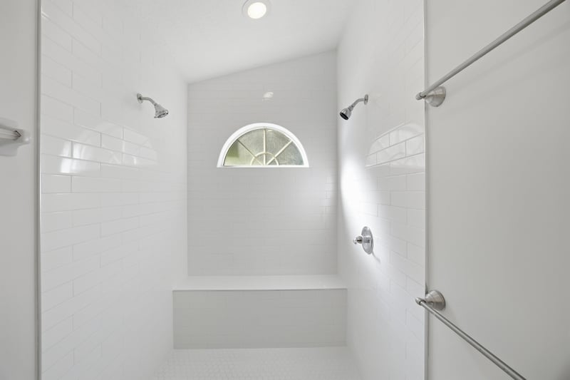 Bathroom shower with arched window at 678 5th Ave N, Jacksonville Beach, FL 32250