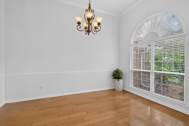 Dining room with arched window and chandelier at 12810 Swamp Owl Ln