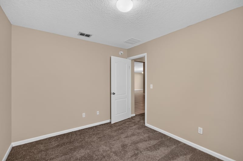 Carpeted bedroom with doorway view at 469 Glendale Ln, Orange Park, FL