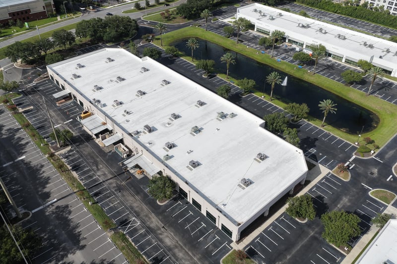 Aerial view of a roofline and surrounding parking lot at 10550 Deerwood Park Blvd, Jacksonville, FL 32256