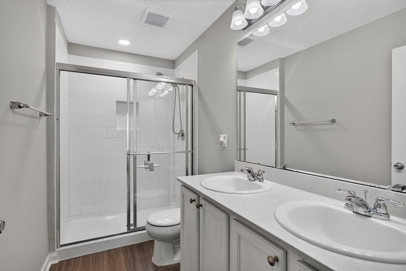 Bathroom with glass shower stall and dual sink vanity at 7118 Preston Pnes Trl, Jacksonville, FL