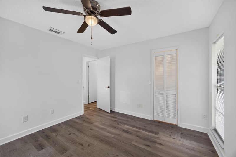 Room with wood floor and multiple doors at 551 Deltona Blvd, St. Augustine, FL 32086
