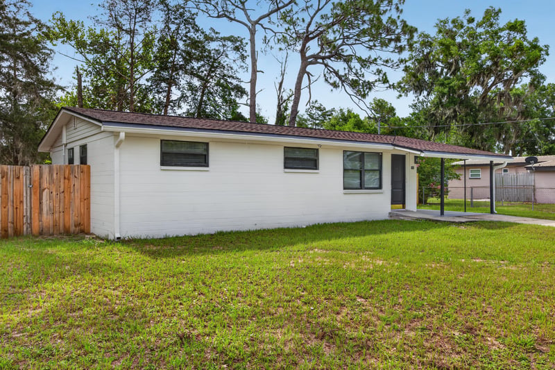 Front exterior with carport and mature trees at 184 Draco St, Orange Park, FL 32073