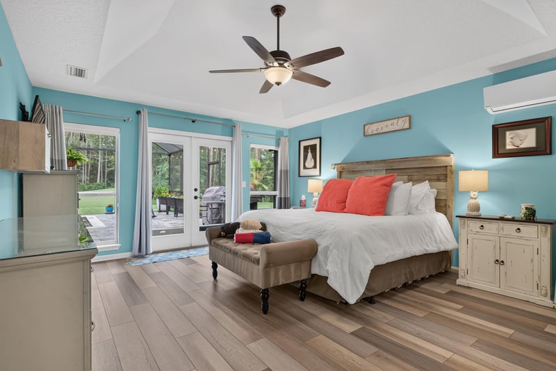 Primary bedroom with teal walls and French doors at 2304 Spring Hill Ct, Orange Park, FL