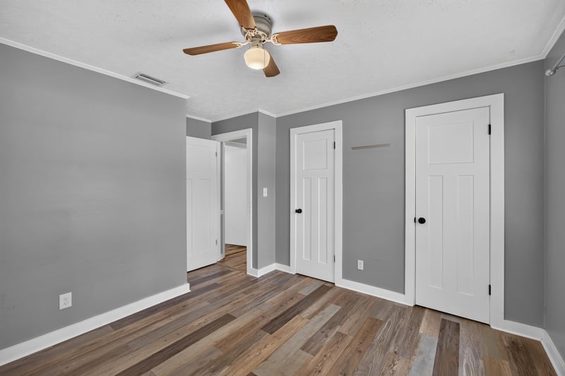 Bedroom with ceiling fan and closet doors at 6757 Deer Springs Rd, Keystone Heights, FL 32656