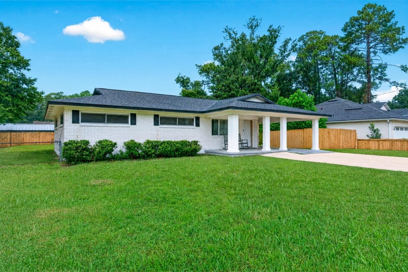 Front exterior view of brick ranch home and driveway at 9506 Harriet Ave, Jacksonville, FL 32208