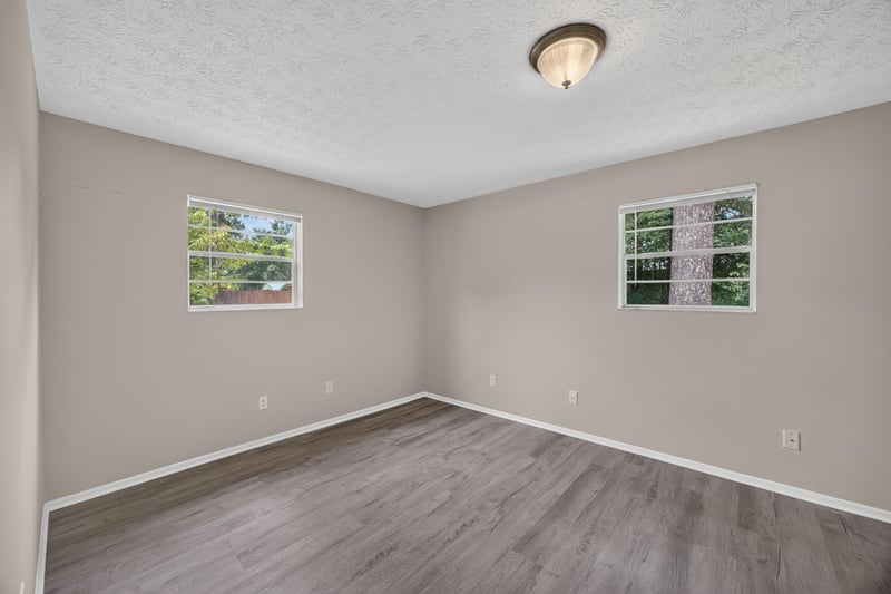 Empty room with two windows and wood-look flooring at 1083 Stokes St, Jacksonville, FL