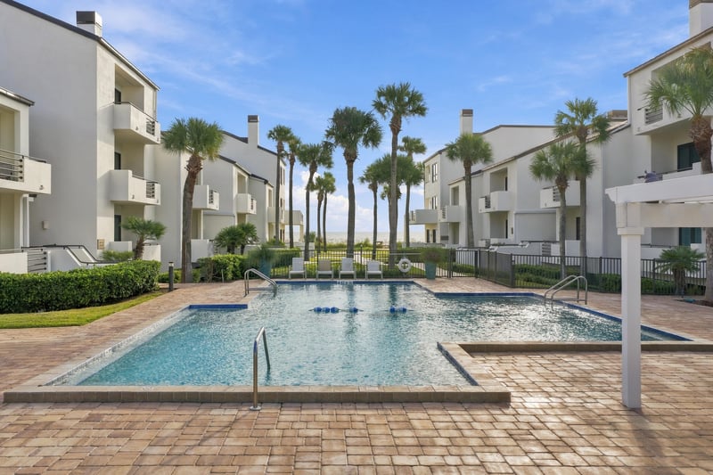 Community pool deck with loungers in Ponte Vedra Beach, FL