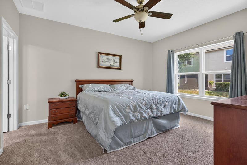 Primary bedroom with ceiling fan and window at 2378 Caney Oaks Dr, Jacksonville, FL