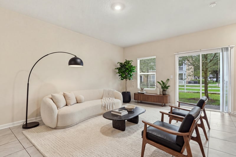 Staged living room with sofa, chairs, and rug at 9555 Star Dr, Jacksonville, FL 32256