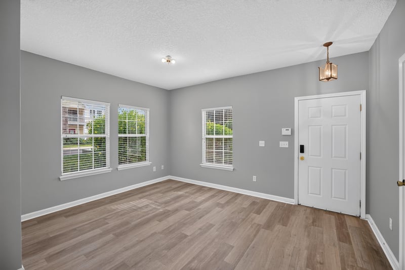 Living room with window and wood-look floor at 575 Oakleaf Plantation Pkwy, Orange Park, FL 32065