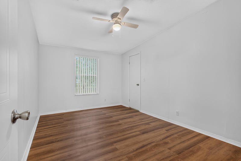 Bedroom with window and wood flooring at 3215 Robin Ln, Middleburg, FL