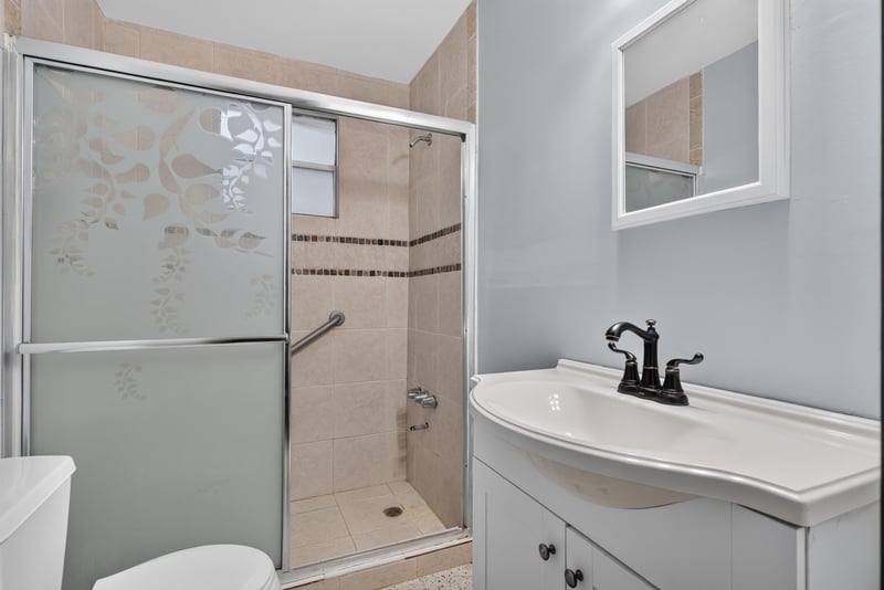 Bathroom with step-in shower and shelving at 5745 110th St, Jacksonville, FL 32244