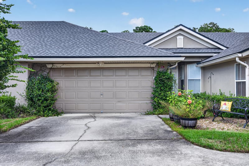 Close view of front exterior with garage and entry at 2131 E Stone Creek Dr, Fleming Island, FL